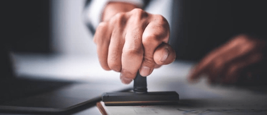 A man stamping a document.