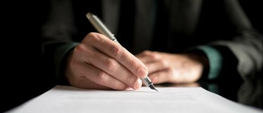 A man signing a contract.